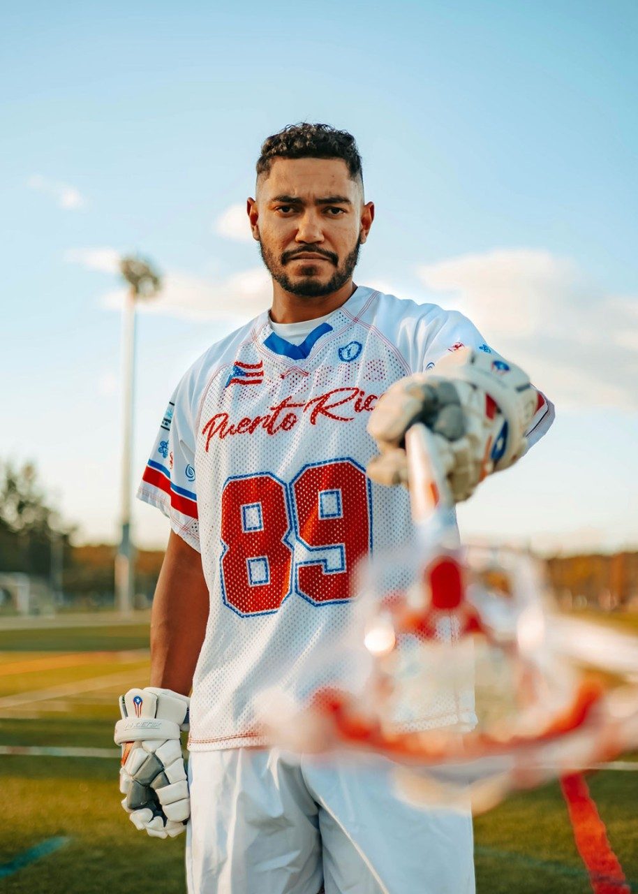 Alex in uniform with his lacrosse stick